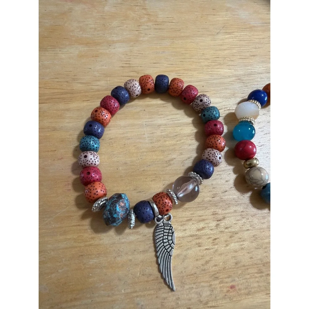 Set of 2 Multi Color Beaded Stretch Bracelets  Silver Wing Charm